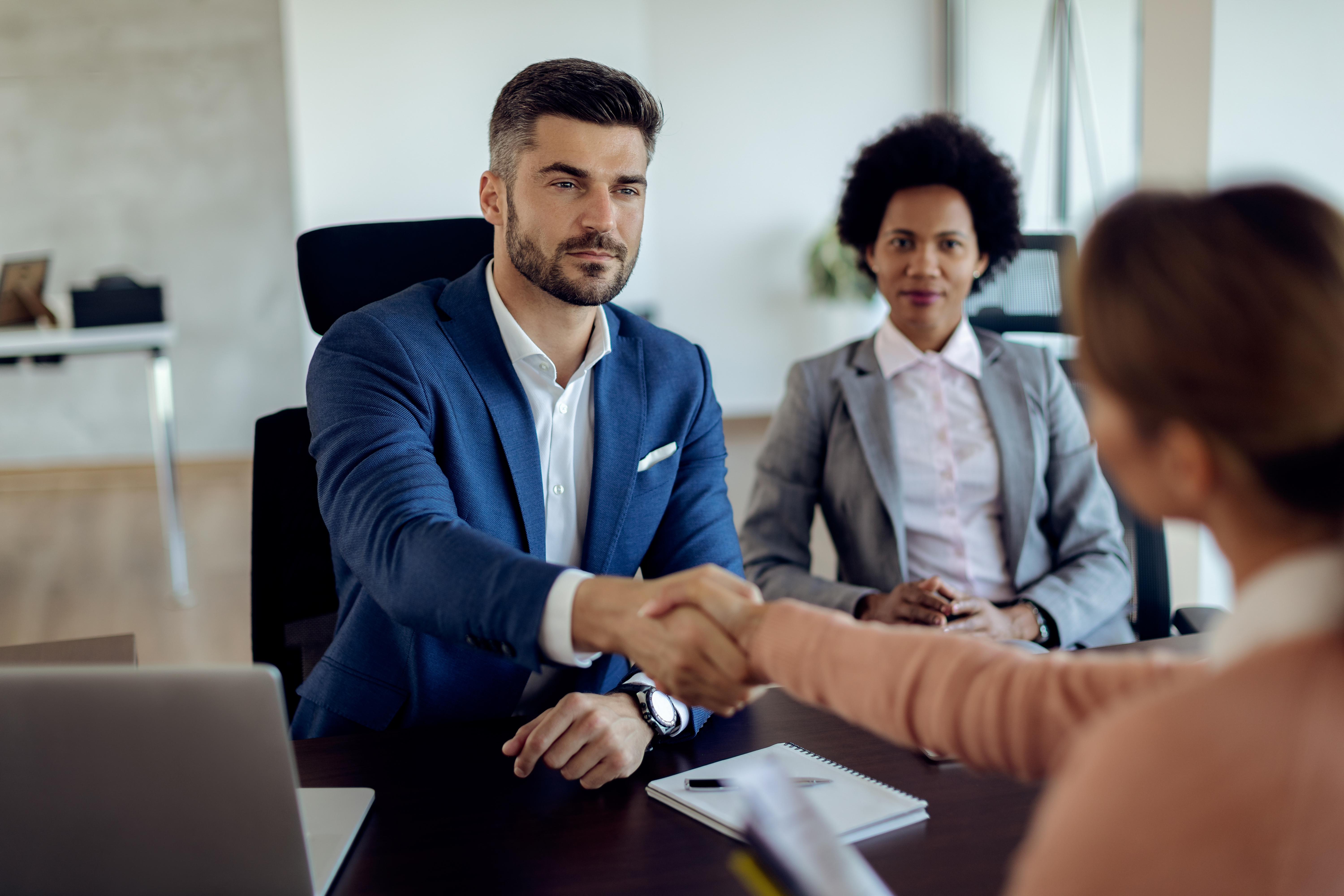 Employer shaking hands with a qualified nursing candidate